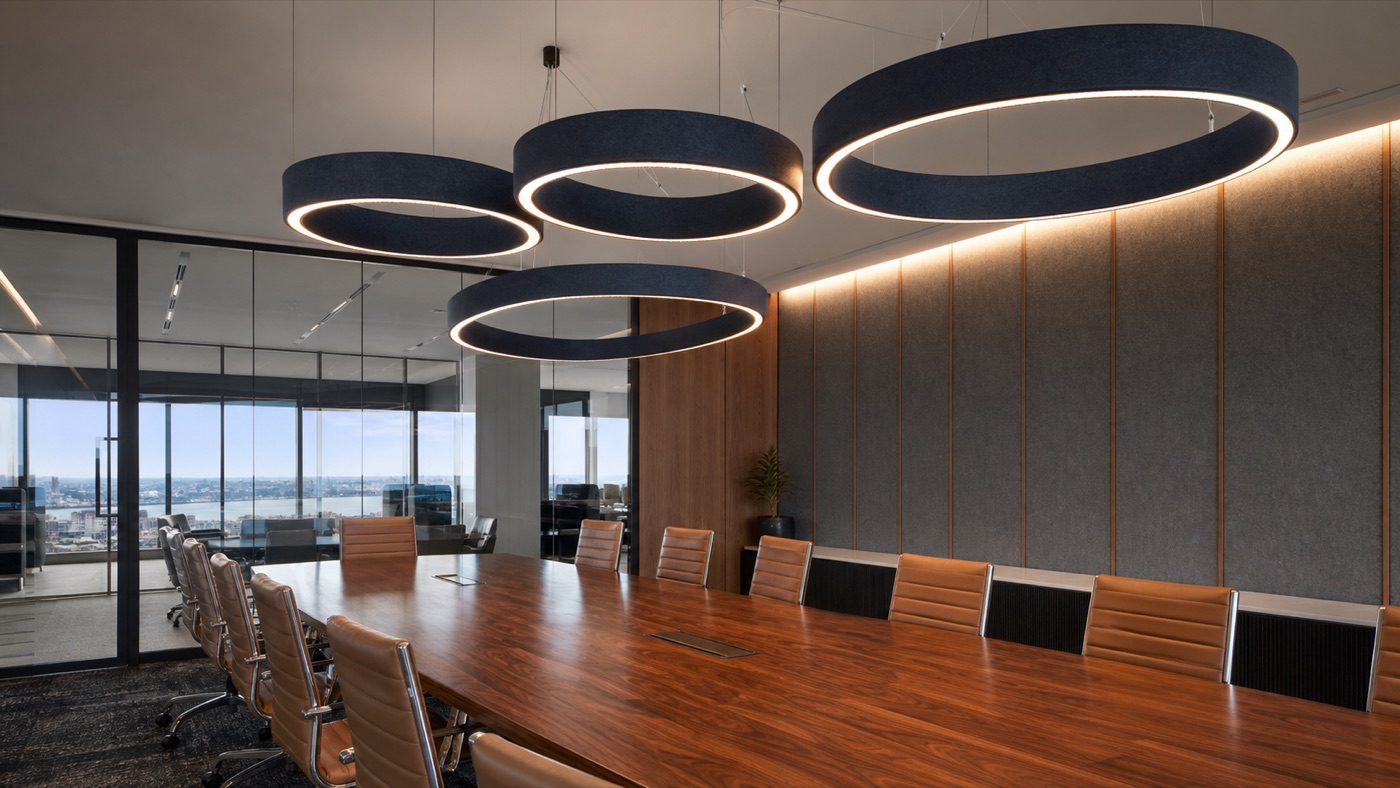 Ring acoustic pendant lighting above a boardroom meeting table