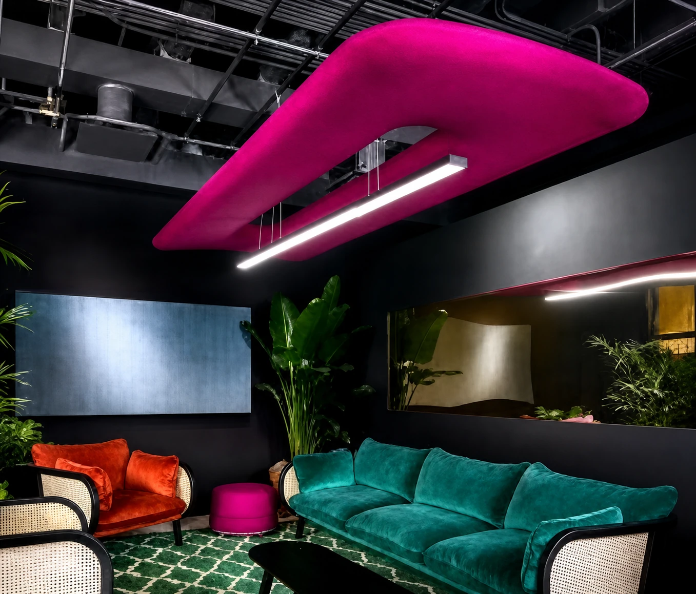 Magenta acoustic ceiling feature with integrated linear light in a dark hospitality lounge